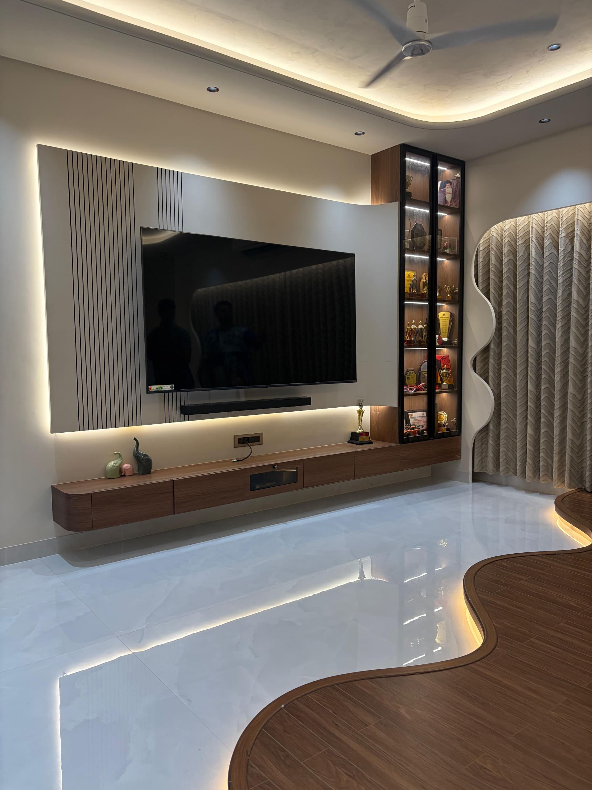 Fluted media wall with trophy cabinet