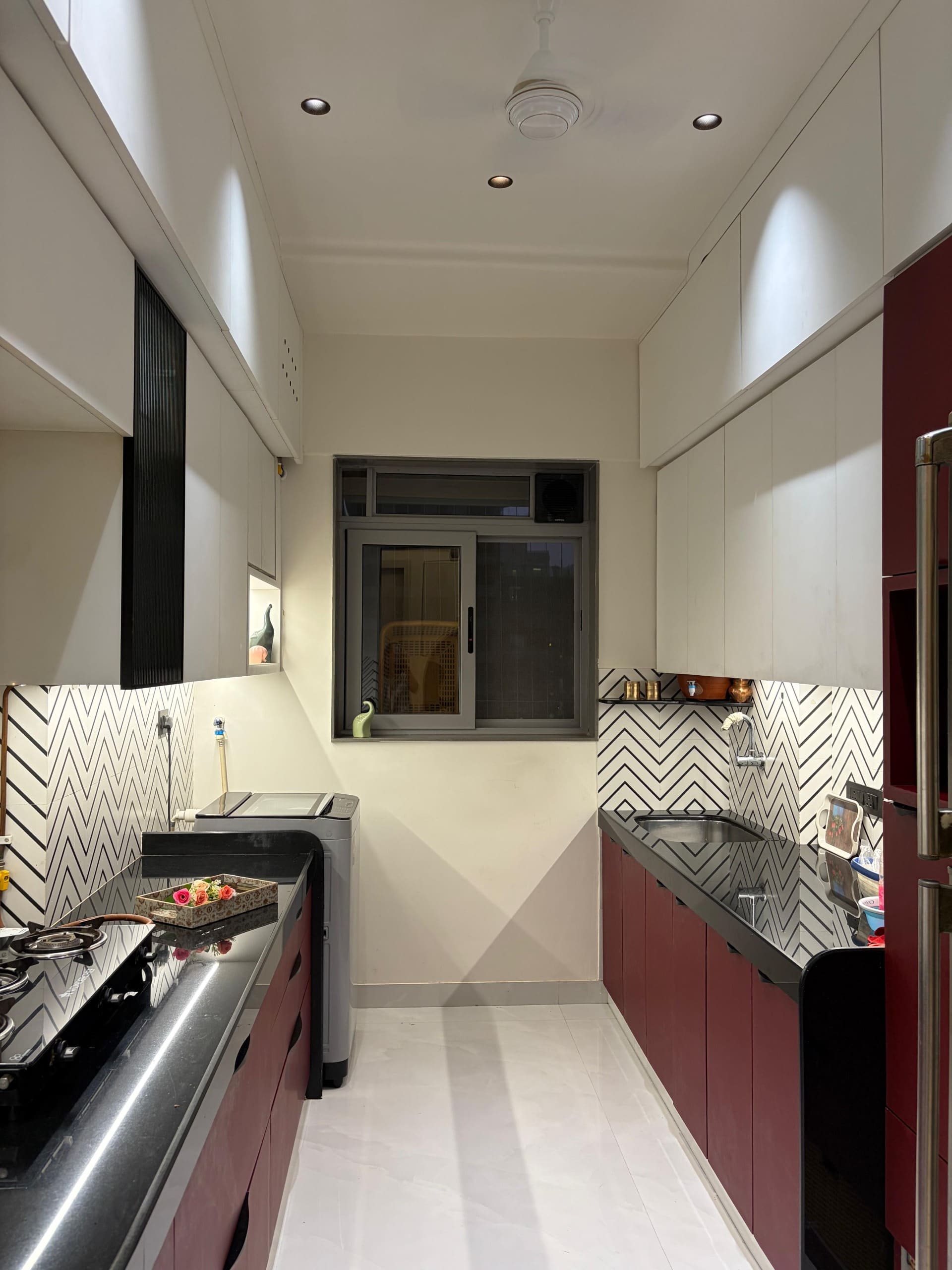 Reeded glass cabinetry over black quartz counter